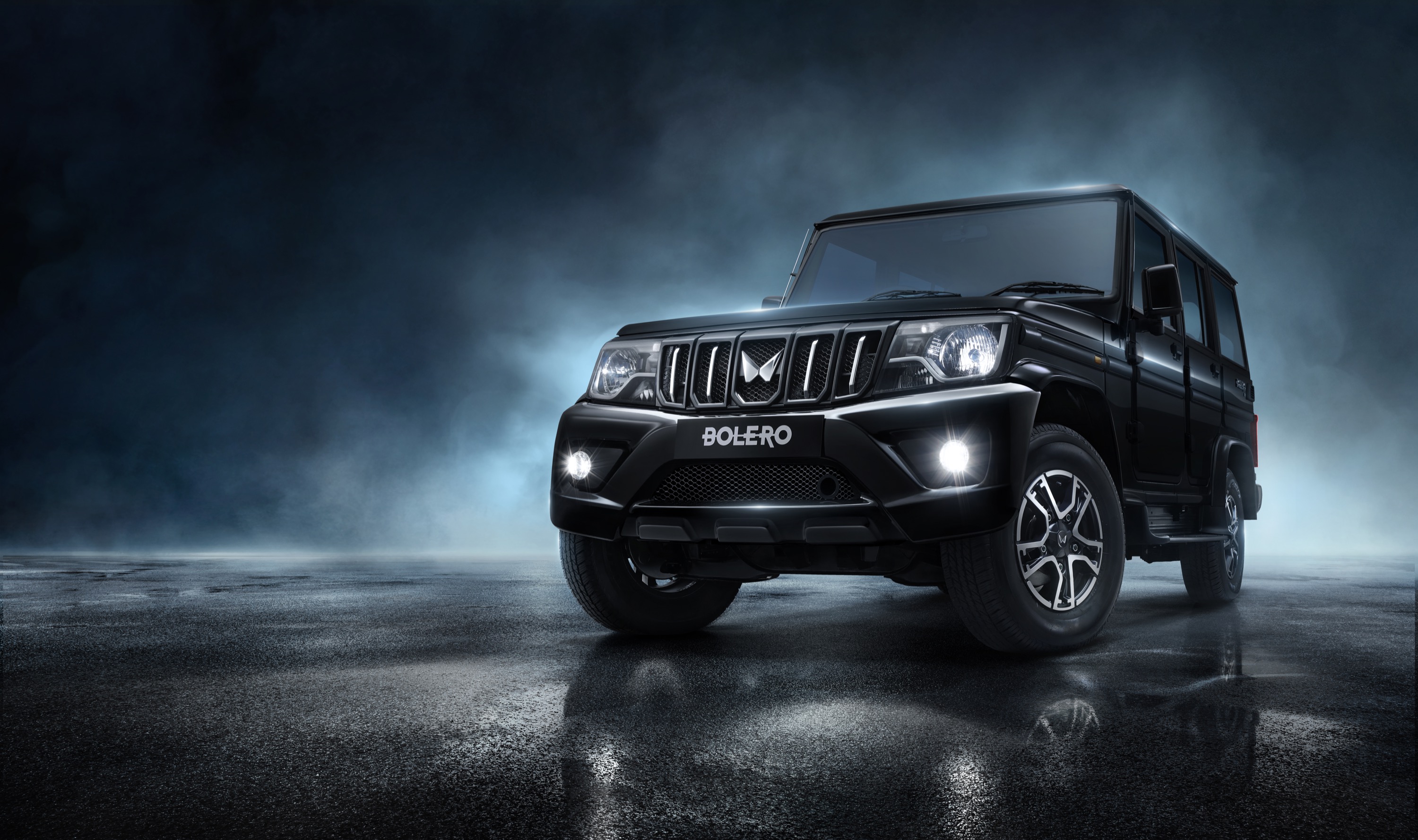 Mahindra Bolero in a dramatic illuminated studio